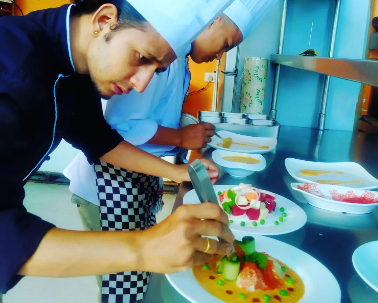 Chefs plating dishes in the D-Town kitchen